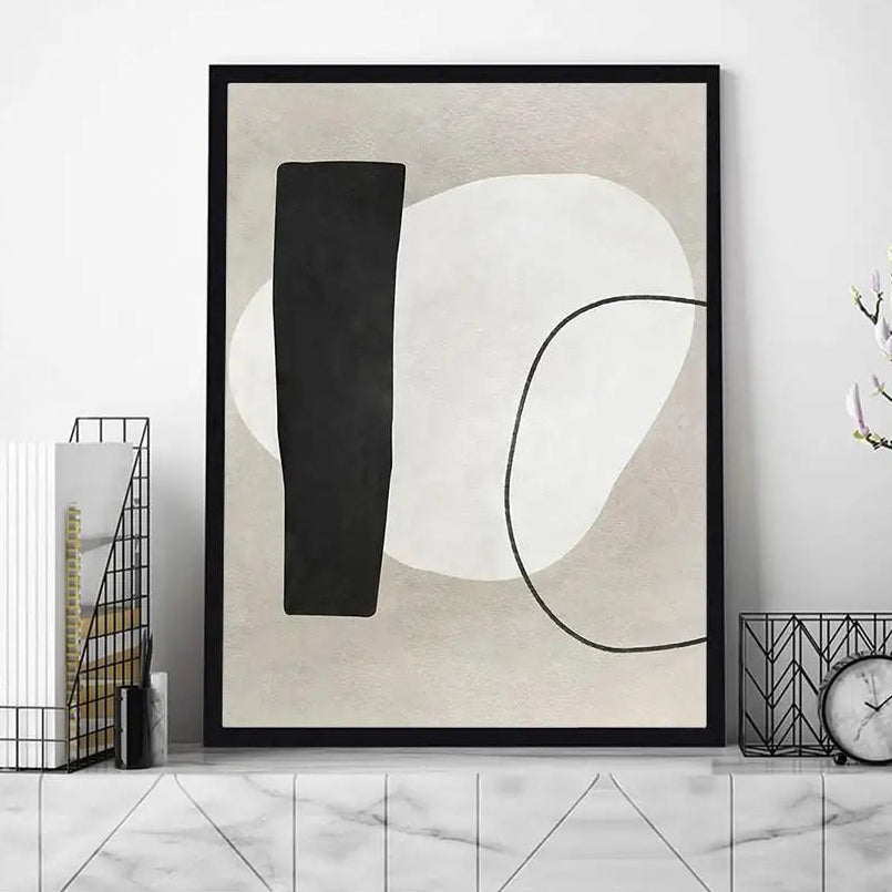 Abstract art print with black and white shapes in a modern interior setting