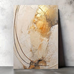 Abstract art piece with gold and beige tones on a textured wall.