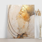 Abstract art piece with gold and beige tones on a white wall.