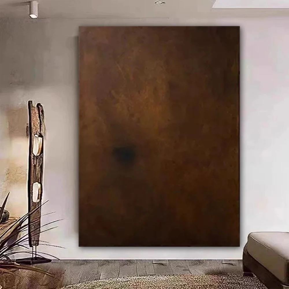 Large abstract brown painting on a wall in a modern interior setting.