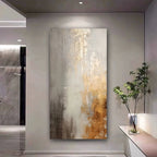 Abstract painting in a modern interior setting with a plant on a side table.