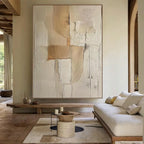 Living room with a large abstract painting on the wall, a sofa, and a coffee table.