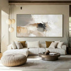 Modern living room with a large abstract painting on the wall, white sofa, and wooden coffee table.