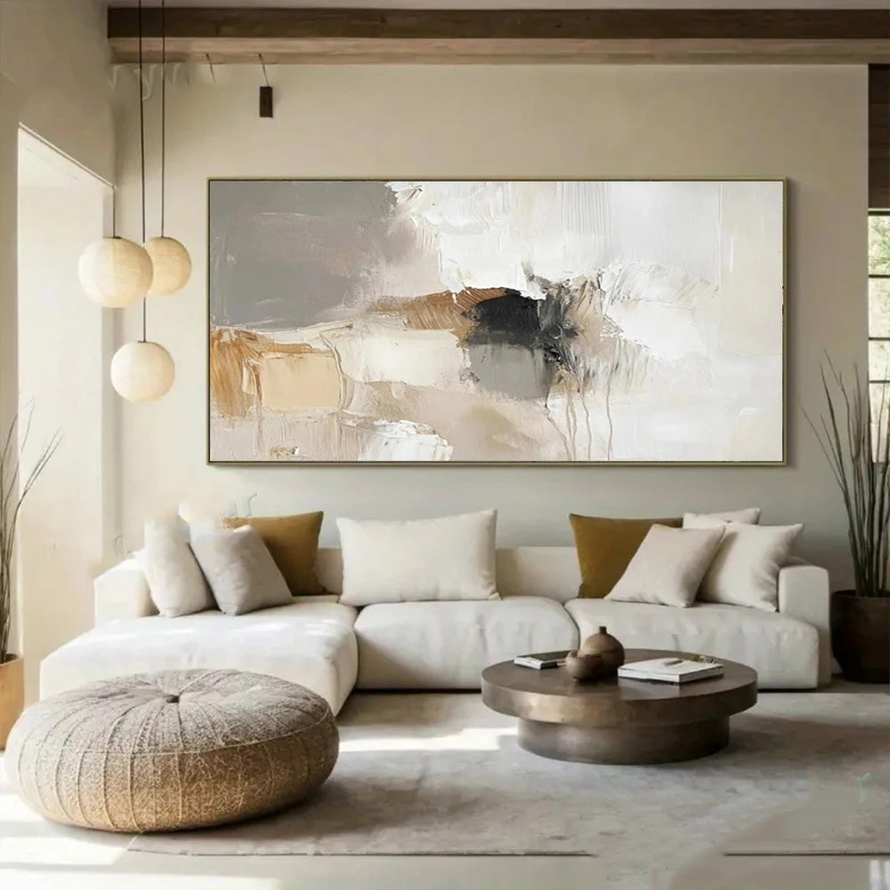 Modern living room with a large abstract painting on the wall, white sofa, and wooden coffee table.