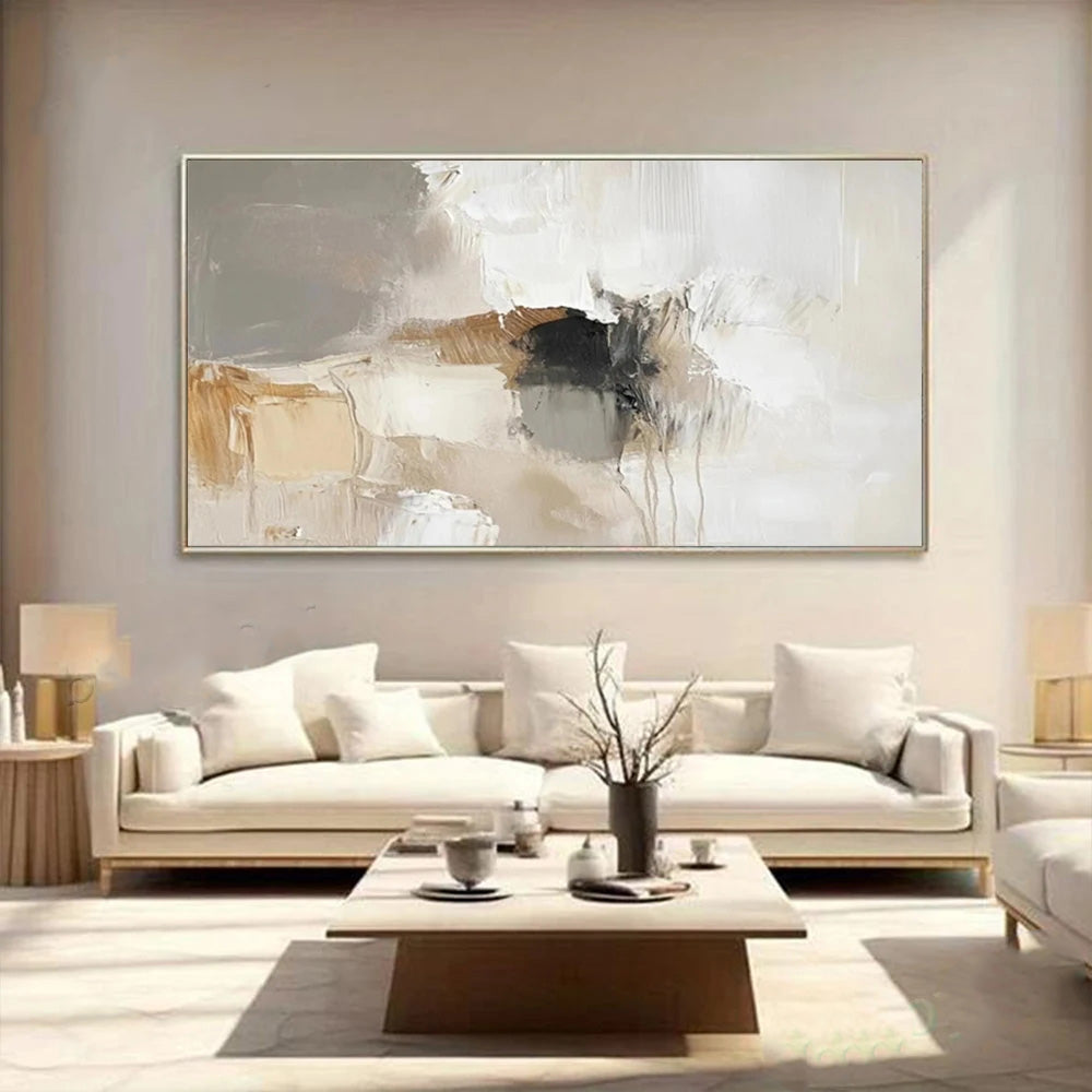 Modern living room with a white sofa, abstract painting, and decorative items.