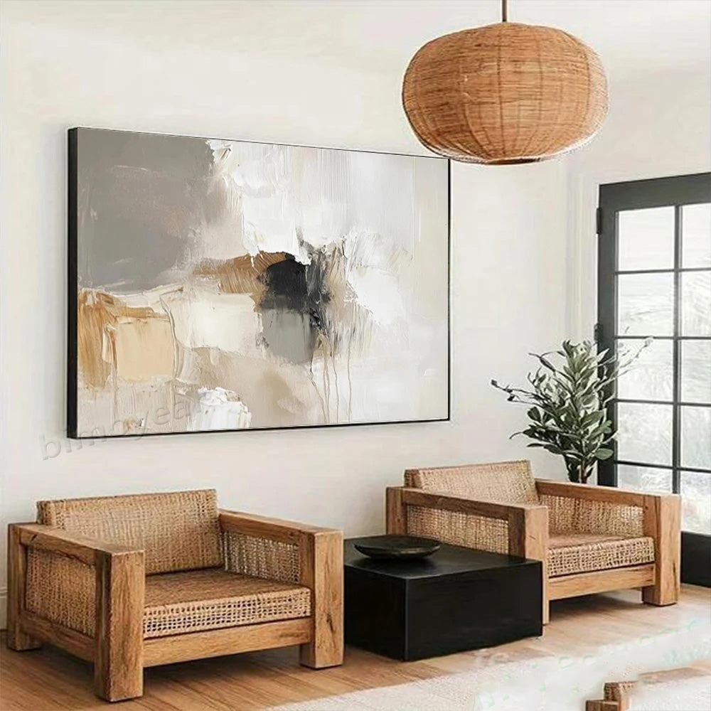 Modern living room with wicker furniture, abstract painting, and pendant light.