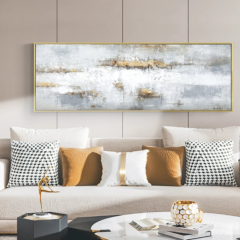 Living room with a large abstract painting above a sofa with decorative pillows.
