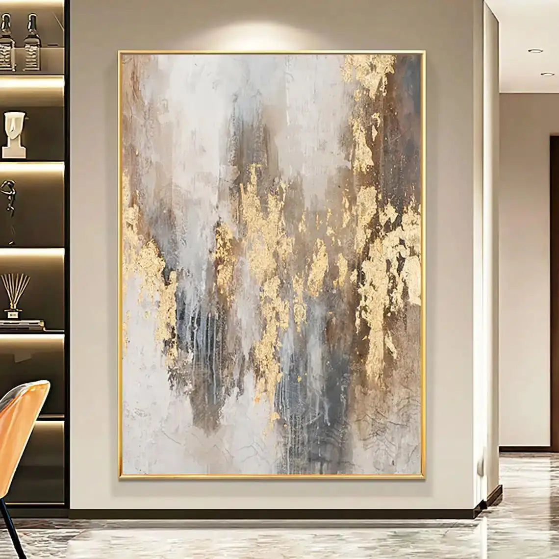 Abstract art painting with gold accents on a wall in a modern interior setting.