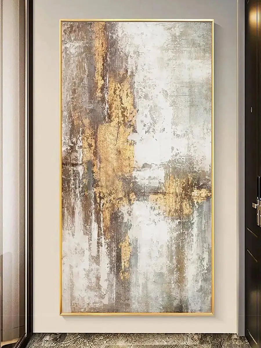 Abstract art painting with gold and gray tones in a gold frame on a wall.