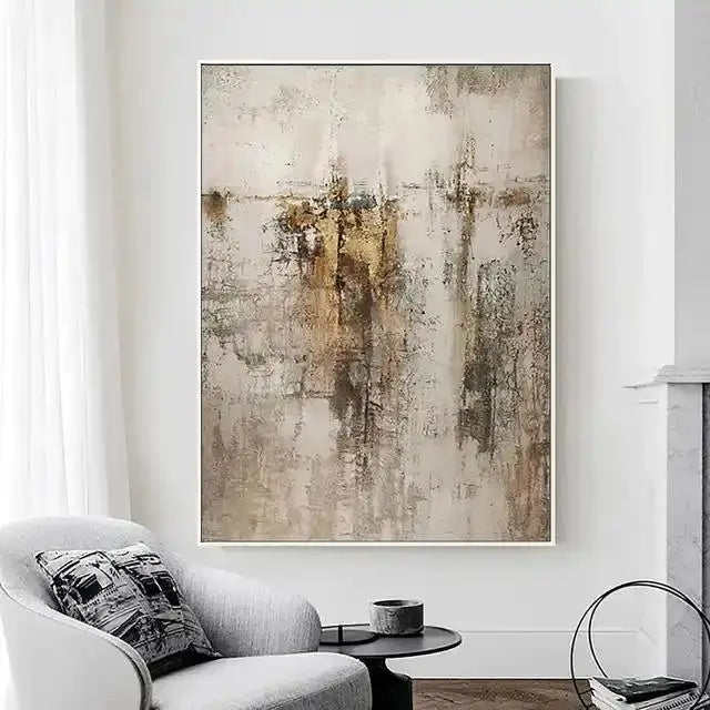 Abstract art painting in a living room setting with a chair and coffee table.