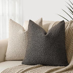 Textured throw pillows on a sofa with a neutral background