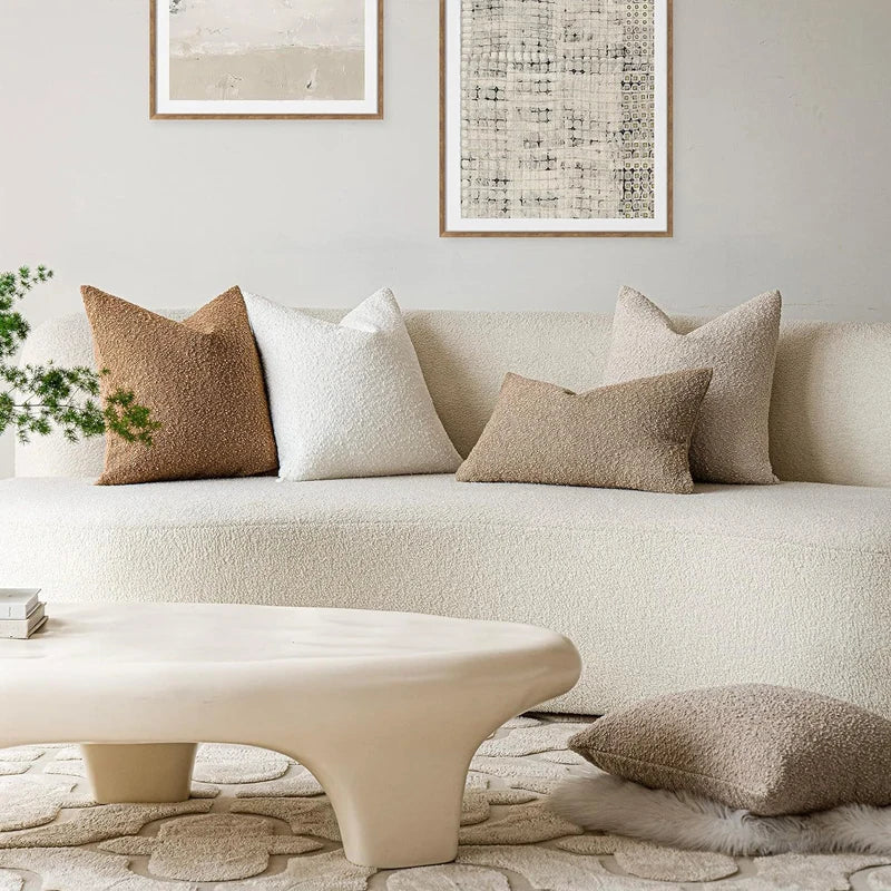 Beige sofa with decorative pillows in a living room setting