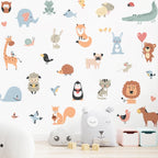 Children's room with animal-themed wall decals and soft toys on a white shelf.