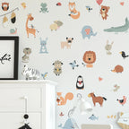 Children's room with animal-themed wall decals on a light gray background.