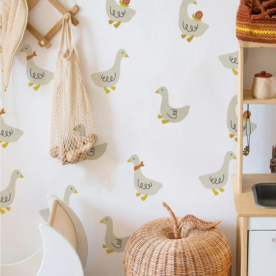 Children's room with duck-themed wallpaper, wicker basket, and wooden shelf.