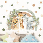Wall decal of a cheetah, giraffe, and elephant surrounded by foliage on a polka dot wall.