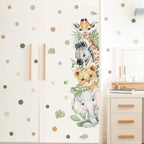Wall decal with giraffe, zebra, and elephant on a polka dot wall.