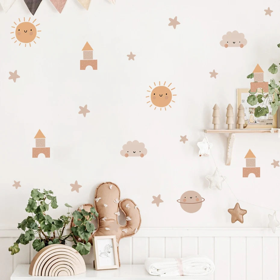 Children's room with decorative wall stickers of suns, stars, and clouds.