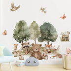 Wall mural with forest animals and trees in a room setting.