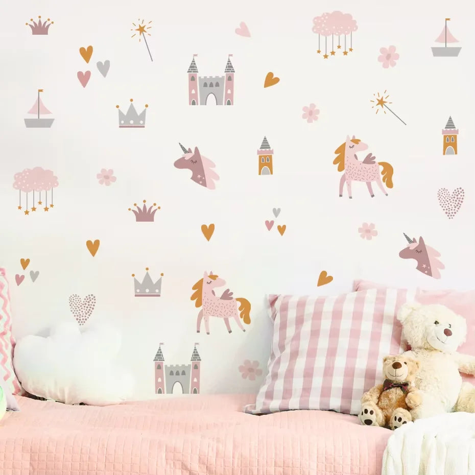 Children's room with pink bedding, teddy bear, and decorative wall stickers of unicorns, castles, and hearts.