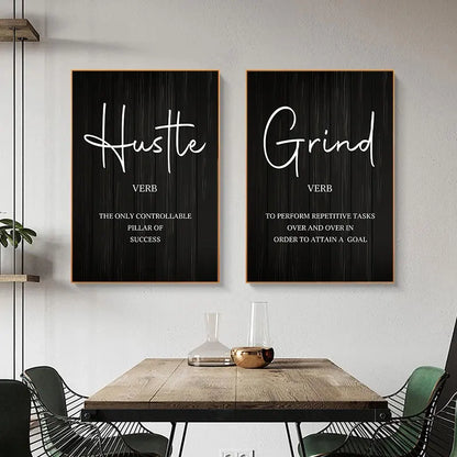 Two framed prints on a wall with motivational phrases 'Hustle' and 'Grind'.