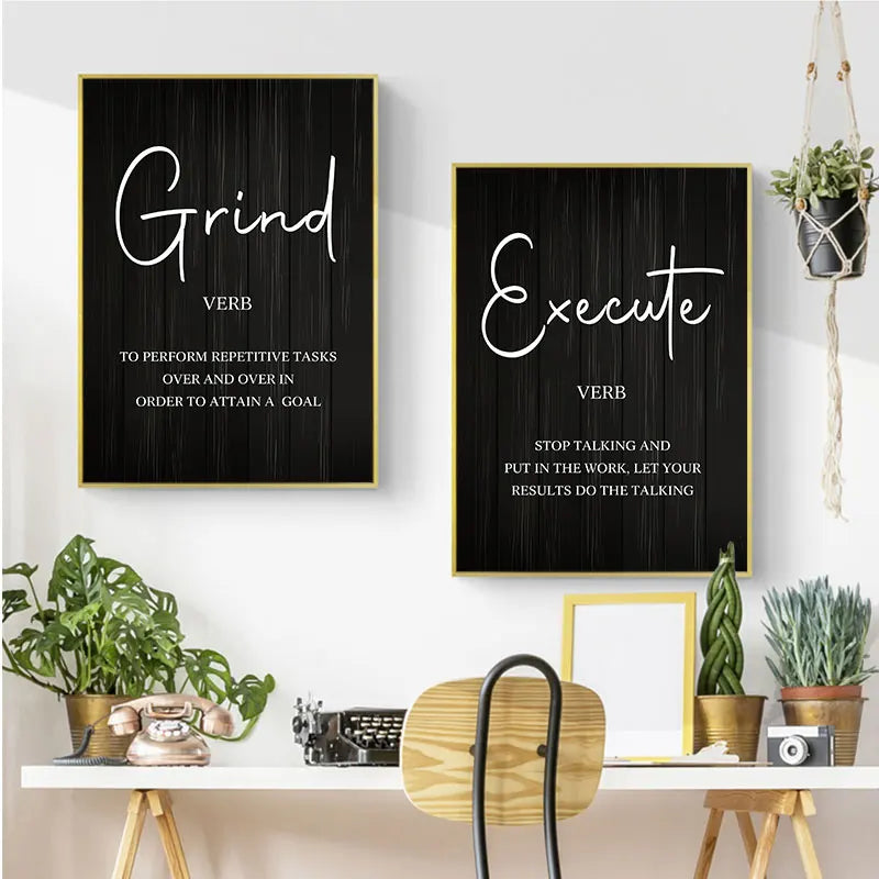 Two motivational posters on a wall with plants and decor below.