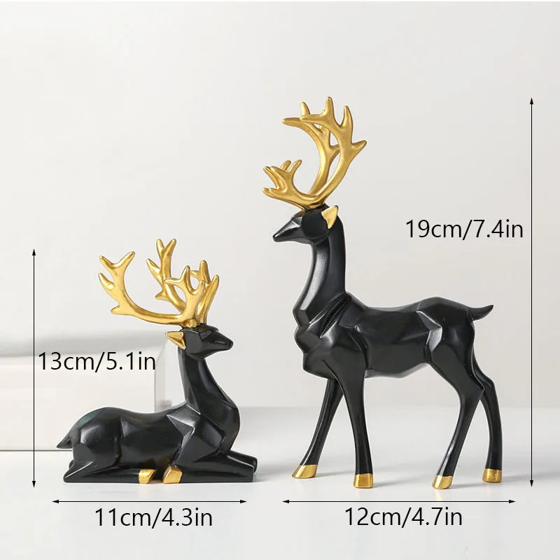 Two black deer figurines with gold antlers and measurements on a white background