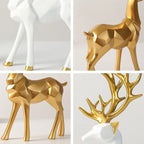 Decorative deer statues in gold and white on a light gray background