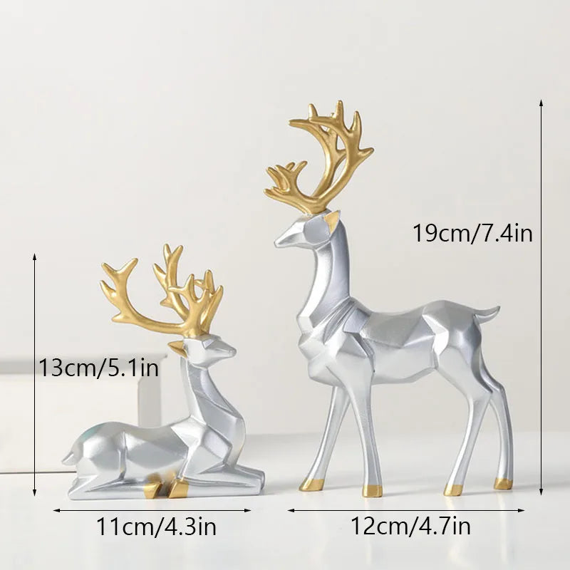 Two deer figurines, one large and one small, with gold antlers on a white background.