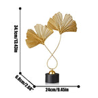 Decorative gold leaf sculpture with measurements on a white background