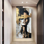 Abstract art piece of a woman's face on a wall in a modern interior setting.