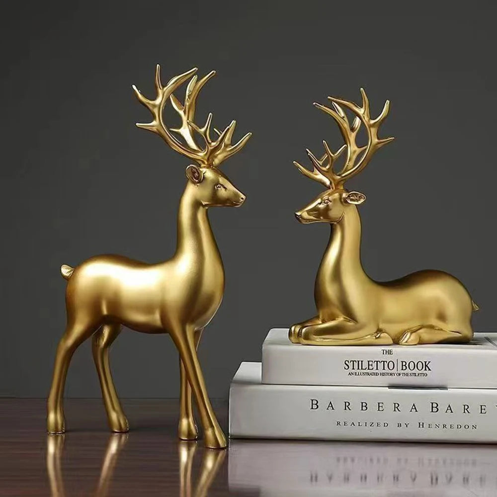 Two gold deer figurines on a dark background
