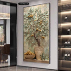 A large framed wall art piece featuring a 3D textured olive tree with gold olives in a pot, displayed in a modern interior setting.