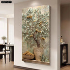 A large vertical canvas wall art print featuring a stylized olive tree with gold olives in a textured pot, displayed on a beige wall in a modern dining room interior.