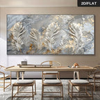 A large rectangular wall art piece featuring a marble-like abstract design with prominent white and silver feathers and gold accents, displayed above a dining table with chairs in a modern interior. A small badge in the top right reads 2D/FLAT.