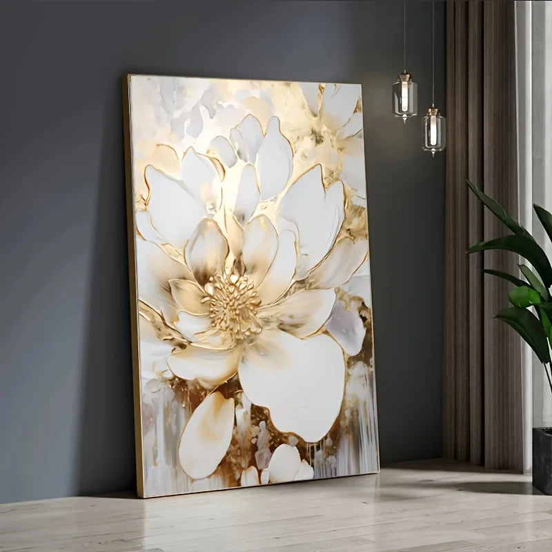 Decorative wall art with a floral design in gold and white on a gray wall.