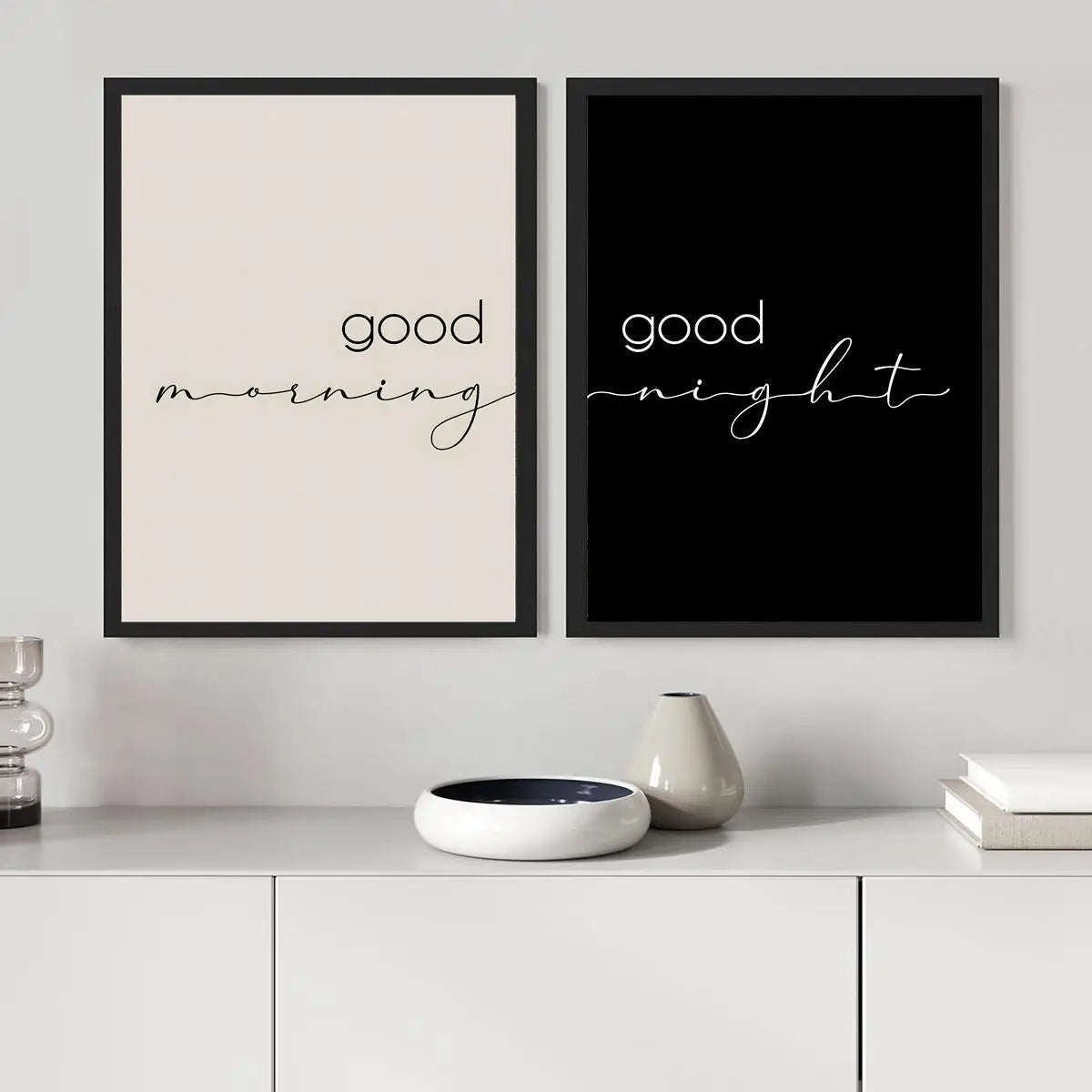 Two framed prints on a wall with 'good morning' and 'good night' text.