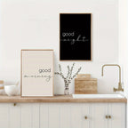 Two framed prints with 'good morning' and 'good night' on a kitchen wall.