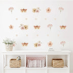 Wall with floral and butterfly decals above a white shelf with decorative items.