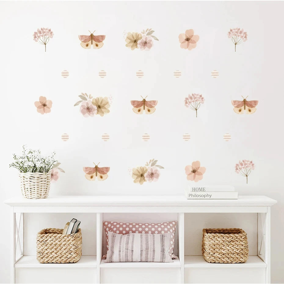 Wall with floral and butterfly decals above a white shelf with decorative items.
