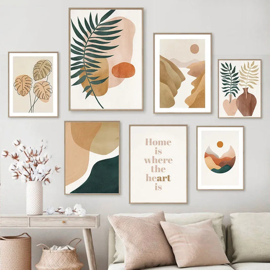 Set of framed artworks on a wall with a sofa and decorative items below.