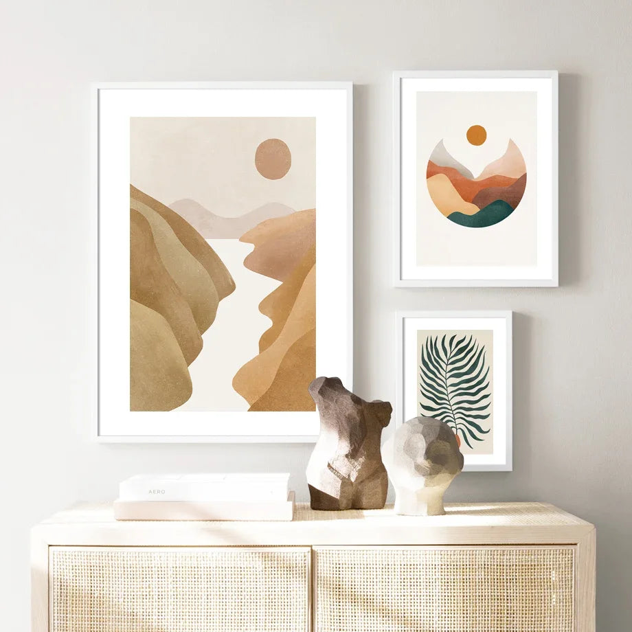 Three framed abstract artworks on a wall above a console table.