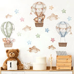 Children's room with wall decals of hot air balloons, stars, and teddy bears.