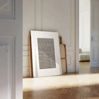 Framed artwork on a wall in a room with wooden flooring