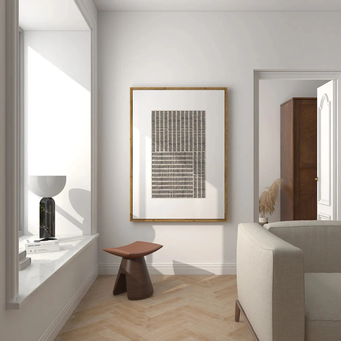 Modern interior with a framed abstract art piece on the wall, a stool, and a sofa.
