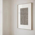 Framed abstract artwork on a plain wall