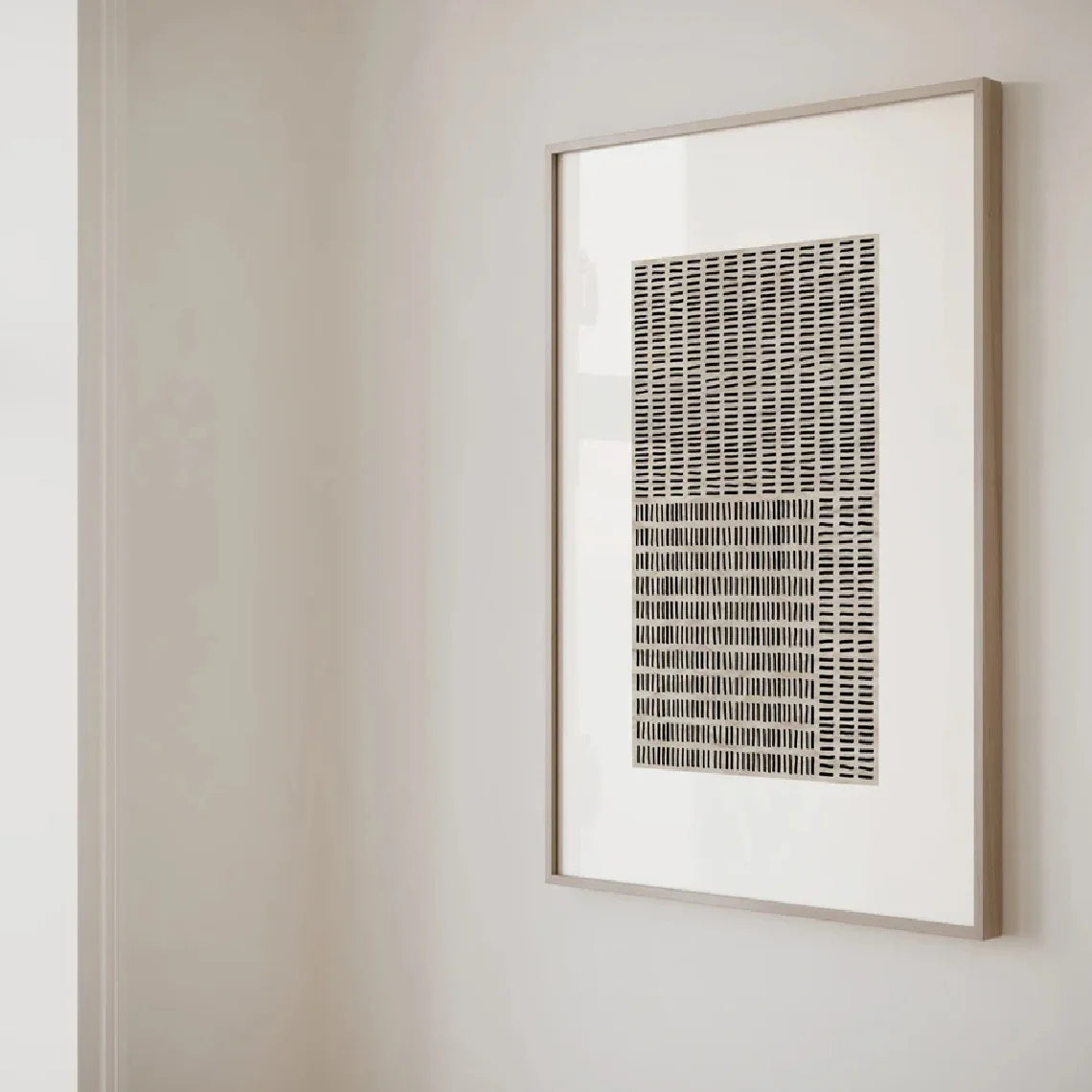 Framed abstract artwork on a plain wall