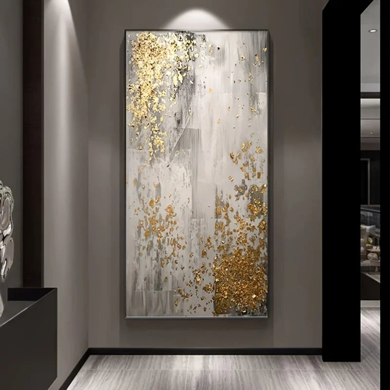 Abstract art piece with gold and gray colors on a wall in a modern interior setting.