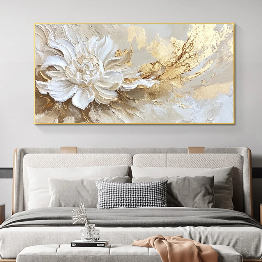 Abstract painting with gold and white floral design above a bed in a bedroom setting.