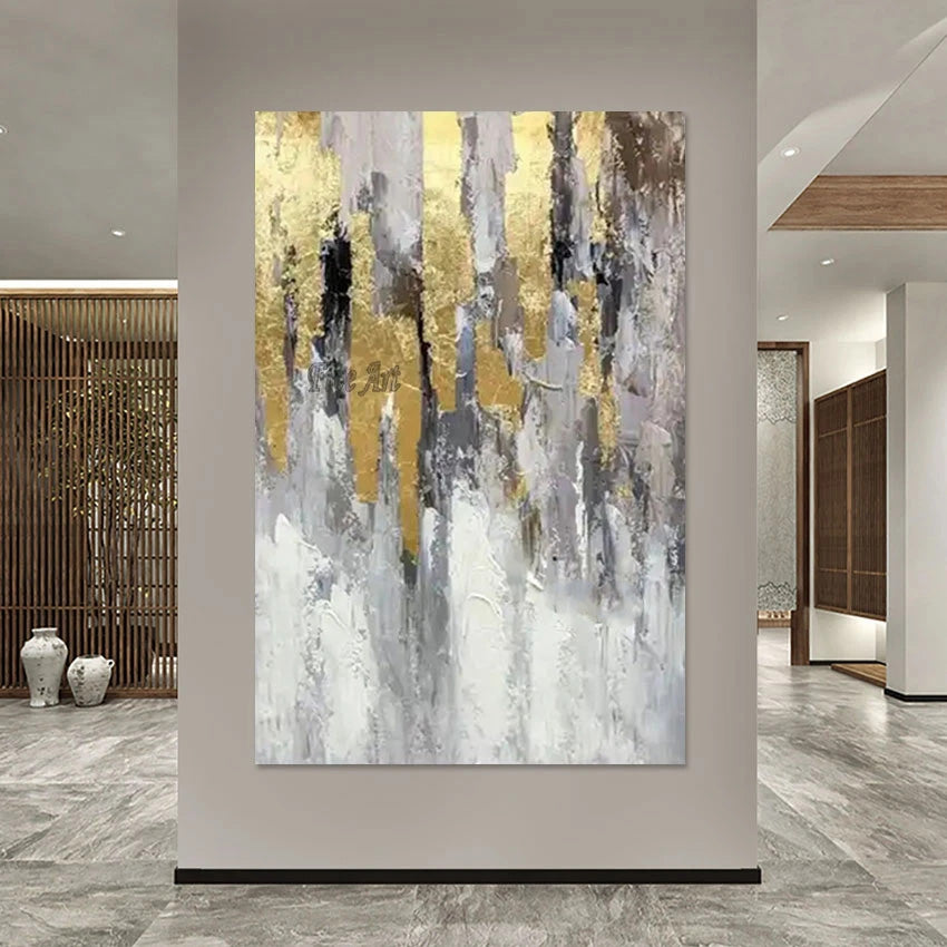 Abstract art painting with gold and gray tones in a modern interior setting.